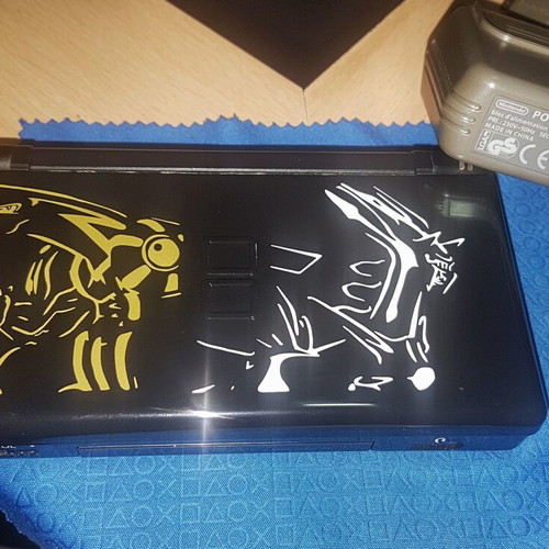 Nintendo DS Lite used with Dialga and Palkia reshell, charger, stylus, and carrying case