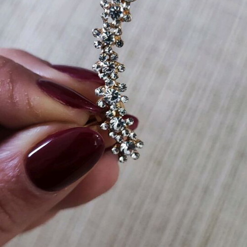 Earring like new, gold color with rhinestones