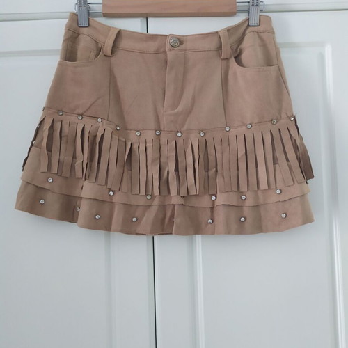 Skirt used with suede-type fringes and matte antique gold details