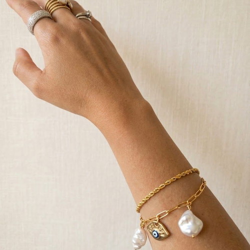 Double steel bracelet with decorative charms and faux pearls