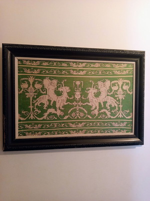Handmade embroidery in large black Corinthian-style frame, used