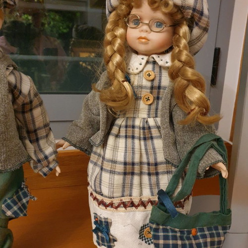 Porcelain dolls new with handmade clothes and support base
