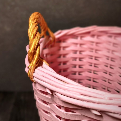 Decorative pink rattan basket with gold handles, handmade