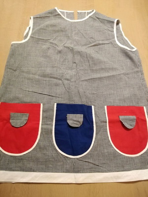 Vintage sleeveless apron used with buttons on back