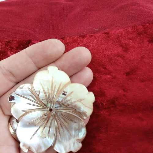 Carved coffee-yellow mother-of-pearl element with hole hibiscus shape