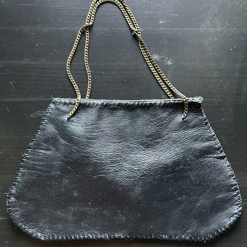 Small handbag like new, black leather with bronze chain handle, leopard interior