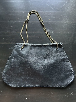 Small handbag like new, black leather with bronze chain handle, leopard interior
