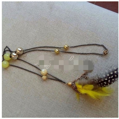 Long necklace new with feathers and yellow beads