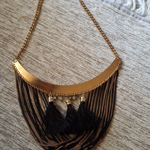Gold necklace like new with black and gold chains and tassels