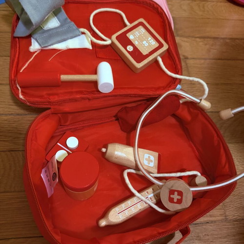 Wooden doctor playset with red first aid bag, used