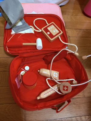 Wooden doctor playset with red first aid bag, used