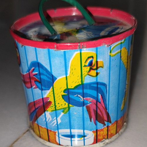 Vintage tin piggy bank used with parrots