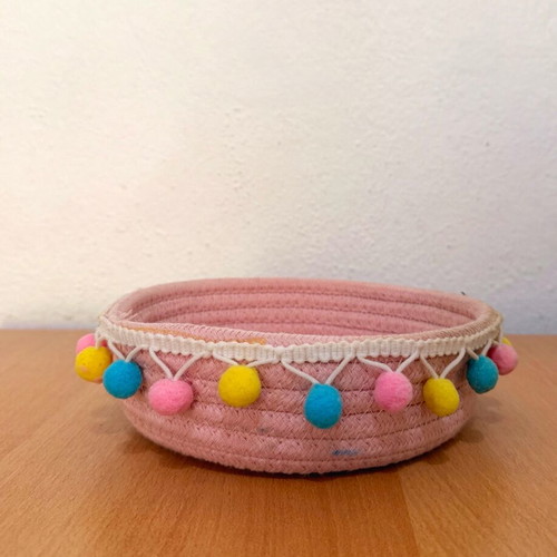 Handmade pink basket with colorful pom poms like new