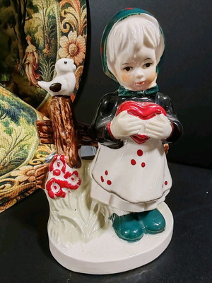 Vintage porcelain figurine of girl with red heart, new