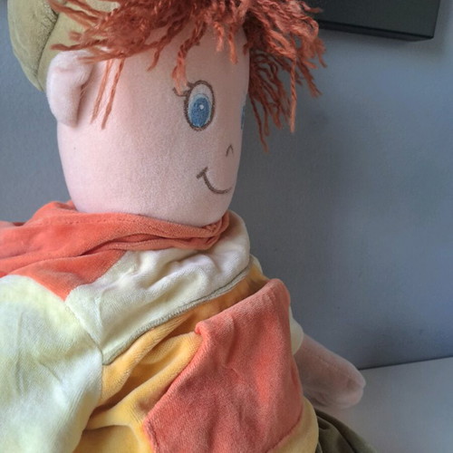 Cloth doll with hat and orange details like new
