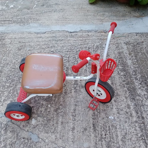 Red children's tricycle with extra foam seat