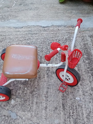 Red children's tricycle with extra foam seat