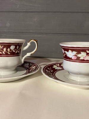Porcelain coffee and tea set with burgundy background and floral design like new