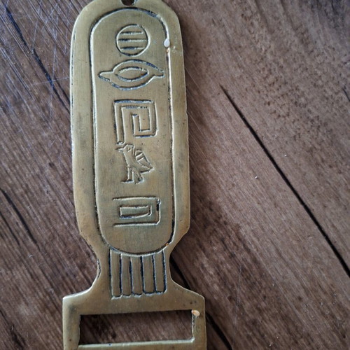 Brass bottle opener with Egyptian hieroglyphs used, 15 cm