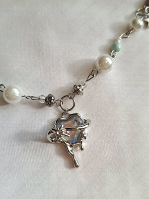 Handmade necklace with metal frame and plastic and metallic beads