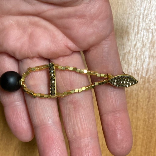Earrings with beads used, gold and black color