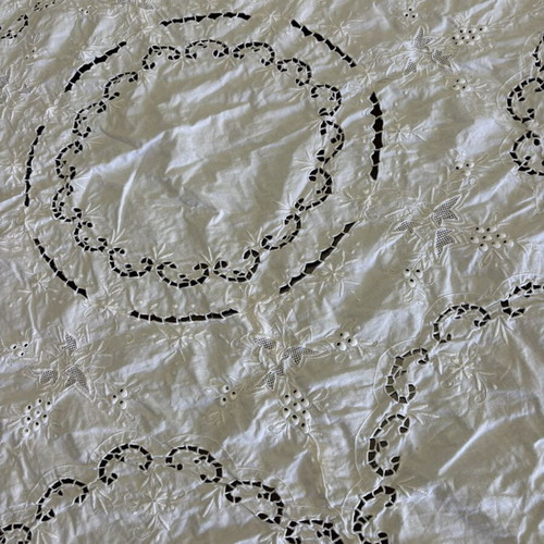 Handmade tablecloth used, cotton fabric with intricate cutwork embroidery