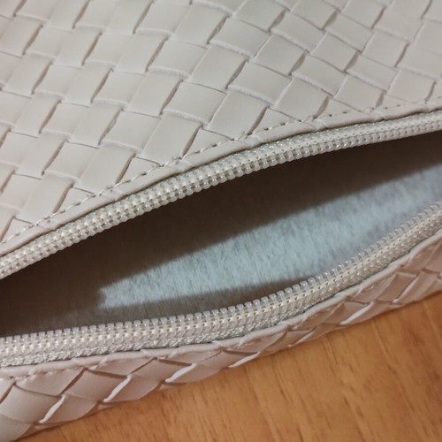 Everyday beige toiletry bag with woven texture and Versace Eros Pour Femme perfume sample