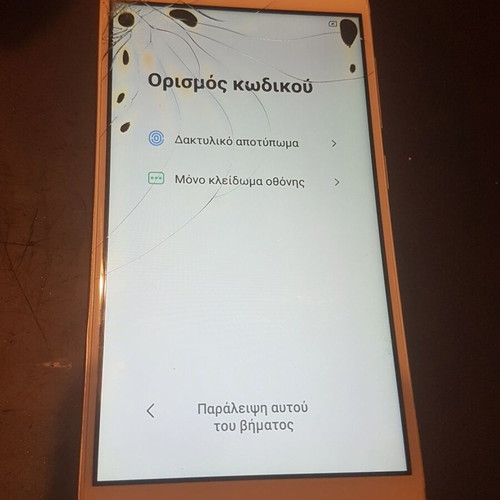 Xiaomi Redmi 4X smartphone with cracked screen, gold