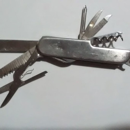 Swiss multi-tool knife with metal handle and multiple tools