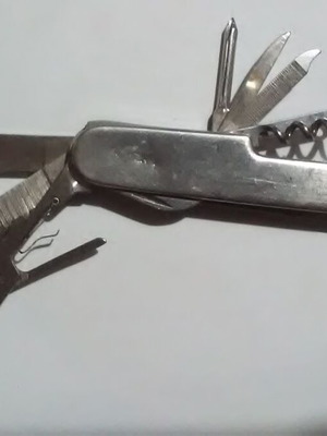 Swiss multi-tool knife with metal handle and multiple tools