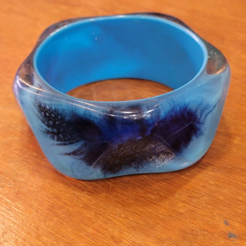 Bracelet with embedded feathers like new