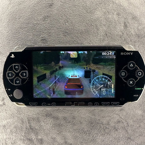 PlayStation Portable PSP-1000 used with charger, 5 games, and Memory Stick