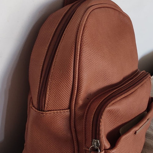 Back pack tan used with internal and external pockets
