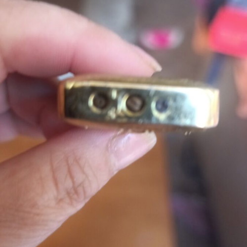Collectible metal lighter used with zodiac symbols and alien motif