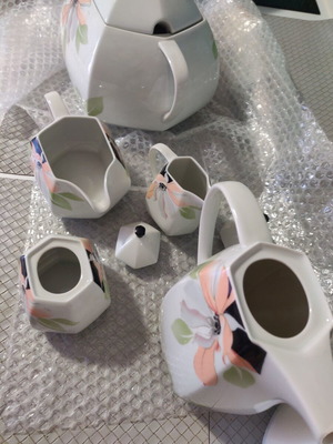 Set of cups and jugs used with lids and saucers