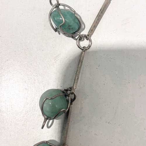 Silver necklace with green precious stones used