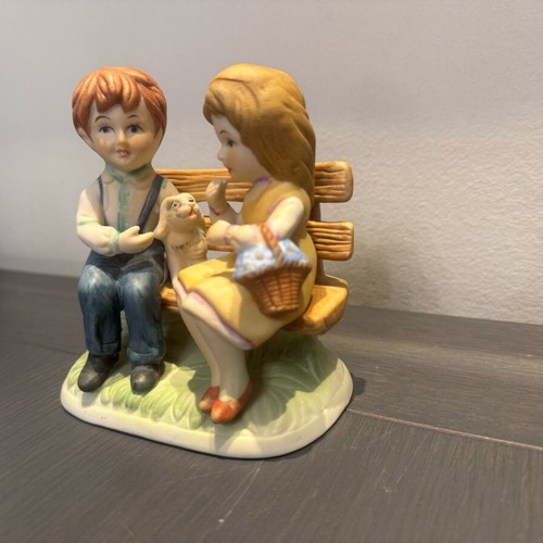 Porcelain decoration with two children on bench like new