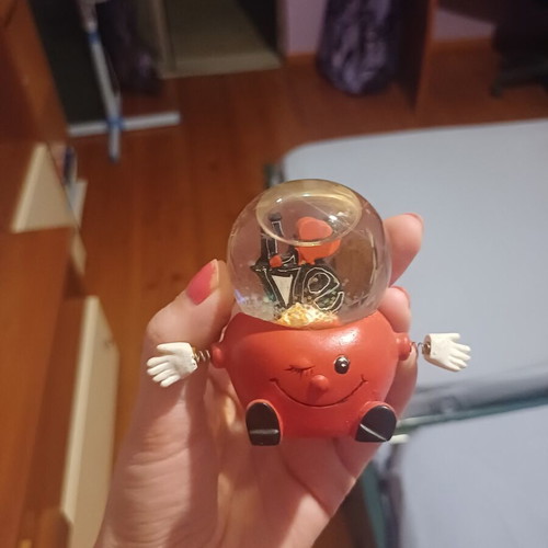 Vintage decorative snow globe with red winking character