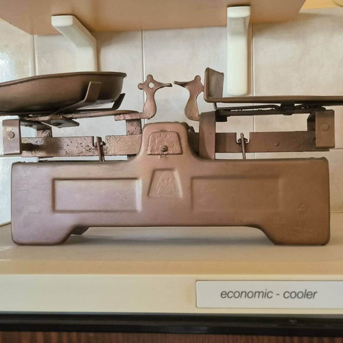 Old mechanical scale with authentic weights, vintage