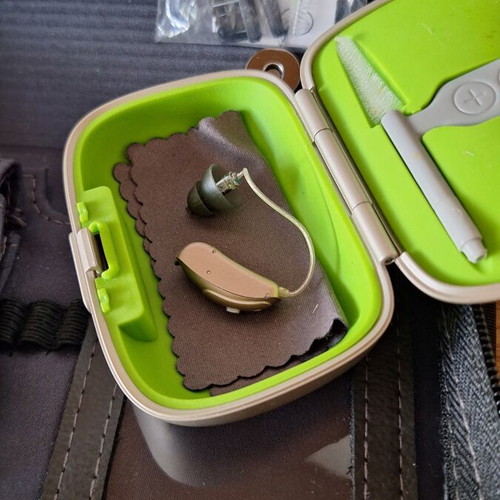 Phonak Audéo V hearing aid with case and cleaning accessories