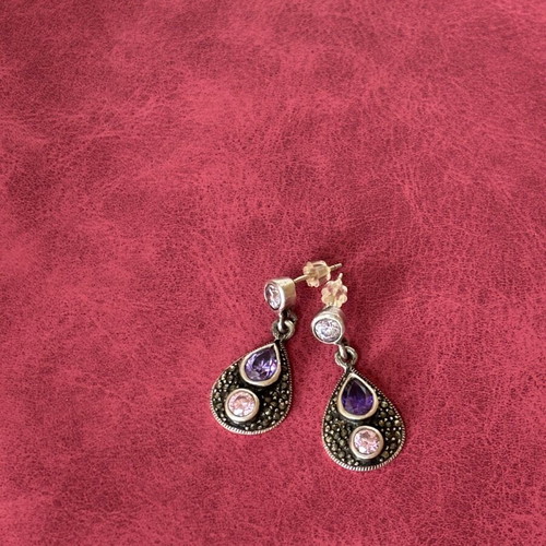 Silver earrings used with purple stones