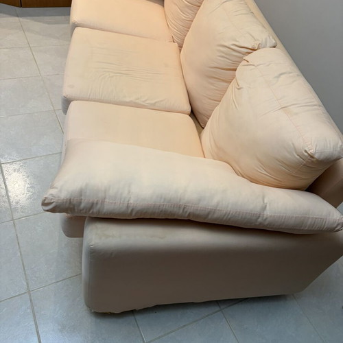 Three-seater fabric sofa used, light pink-peach color with side cushions