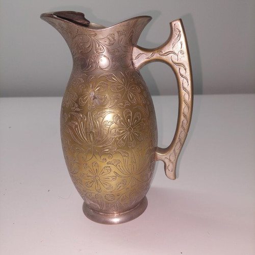 Antique brass jug with silver plating and floral engravings used