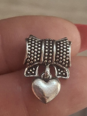 Charm for bracelets used, bow with hanging heart and pink stones