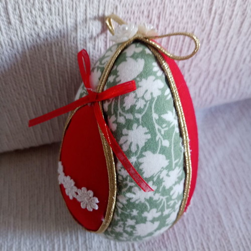 Decorative egg used red and pistachio with daisies