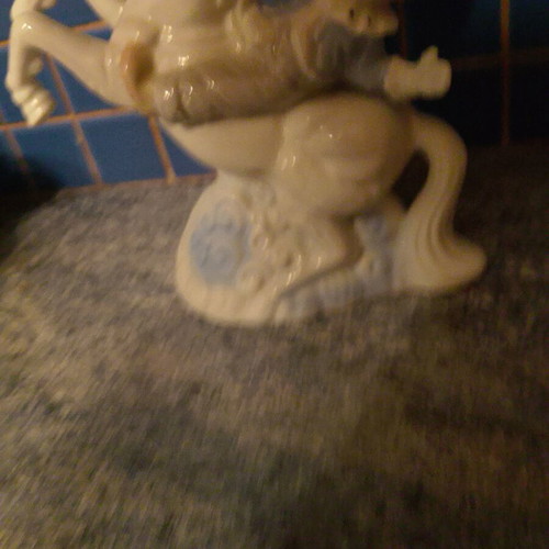 Vintage ceramic clown figurine riding a unicorn used