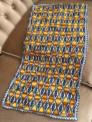 Embroidered table runner with diamond pattern