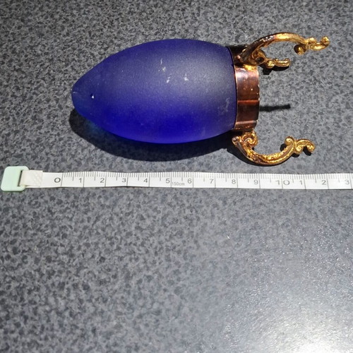 Vintage decorative crystal egg with blue matte glass and gold metal base used