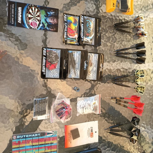 Winmau Blade 5 dartboard used with darts and wooden backing