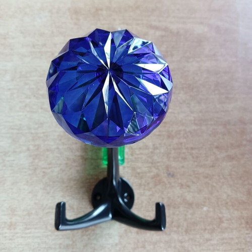 Decorative blue hook with glass-like plastic and metal base